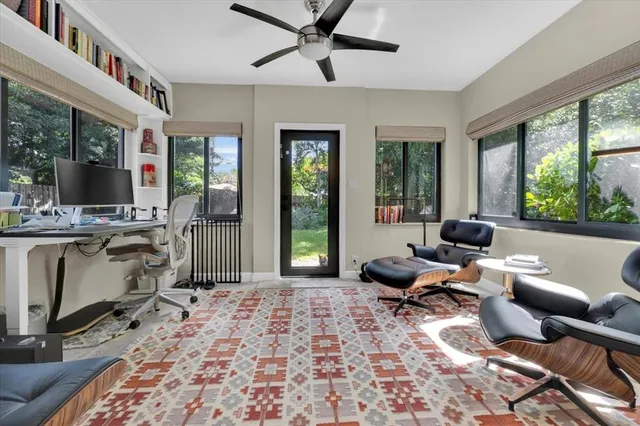 a living room with furniture and large windows