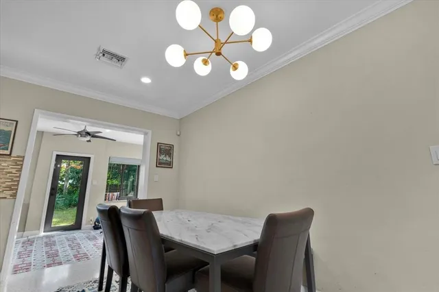 a view of a dining room with furniture and a large window