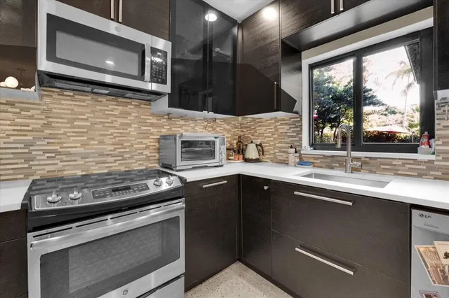 a kitchen with stainless steel appliances a stove sink and microwave