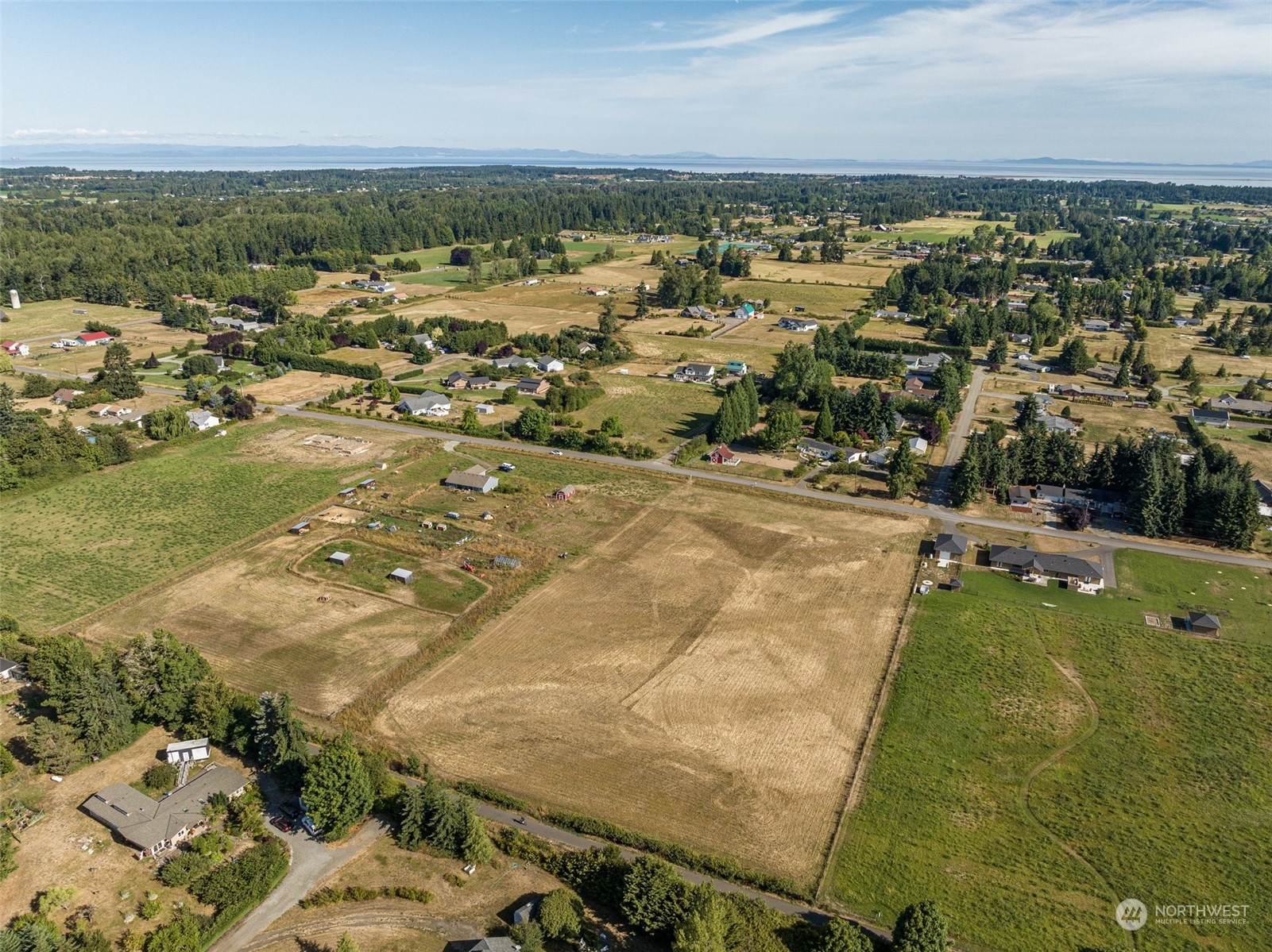 1575 West Hendrickson Road Sequim, WA 98382 - Photo 3 of 16 an aerial view of residential houses with outdoor space