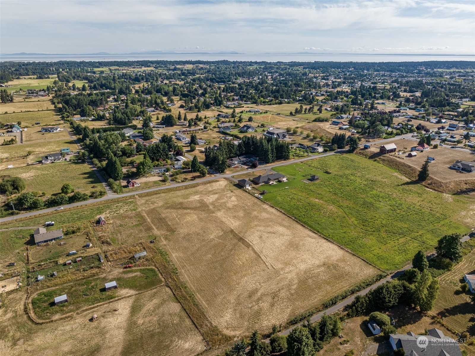 1575 West Hendrickson Road Sequim, WA 98382 - Photo 4 of 16 an aerial view of residential houses with outdoor space