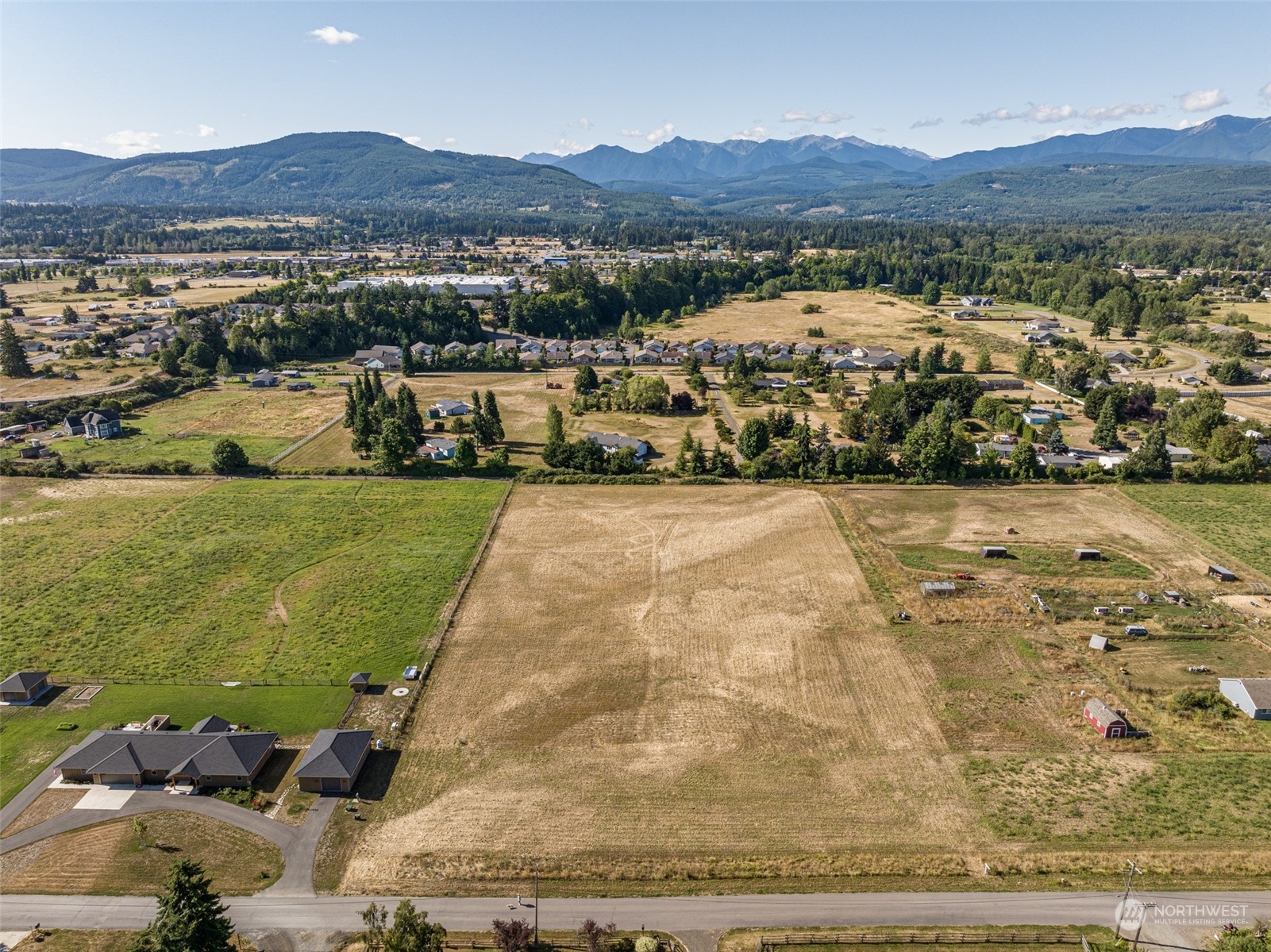 1575 West Hendrickson Road Sequim, WA 98382 - Photo 7 of 16 a view of a lush green hillside and houses
