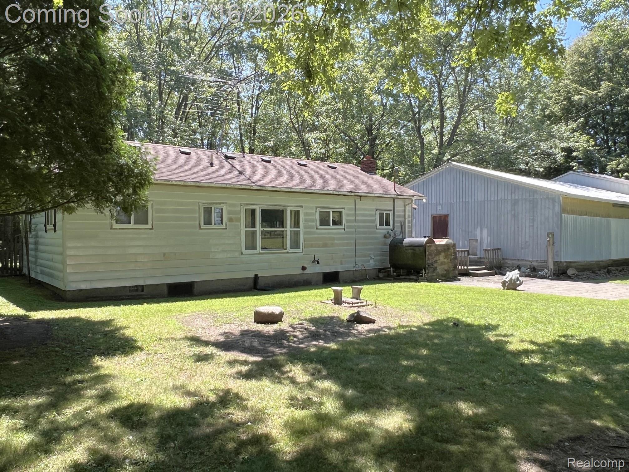 904 West Lovejoy Road Perry, MI 48872 - Photo 11 of 21 Single-story residence featuring light-colored siding and a dark shingle roof