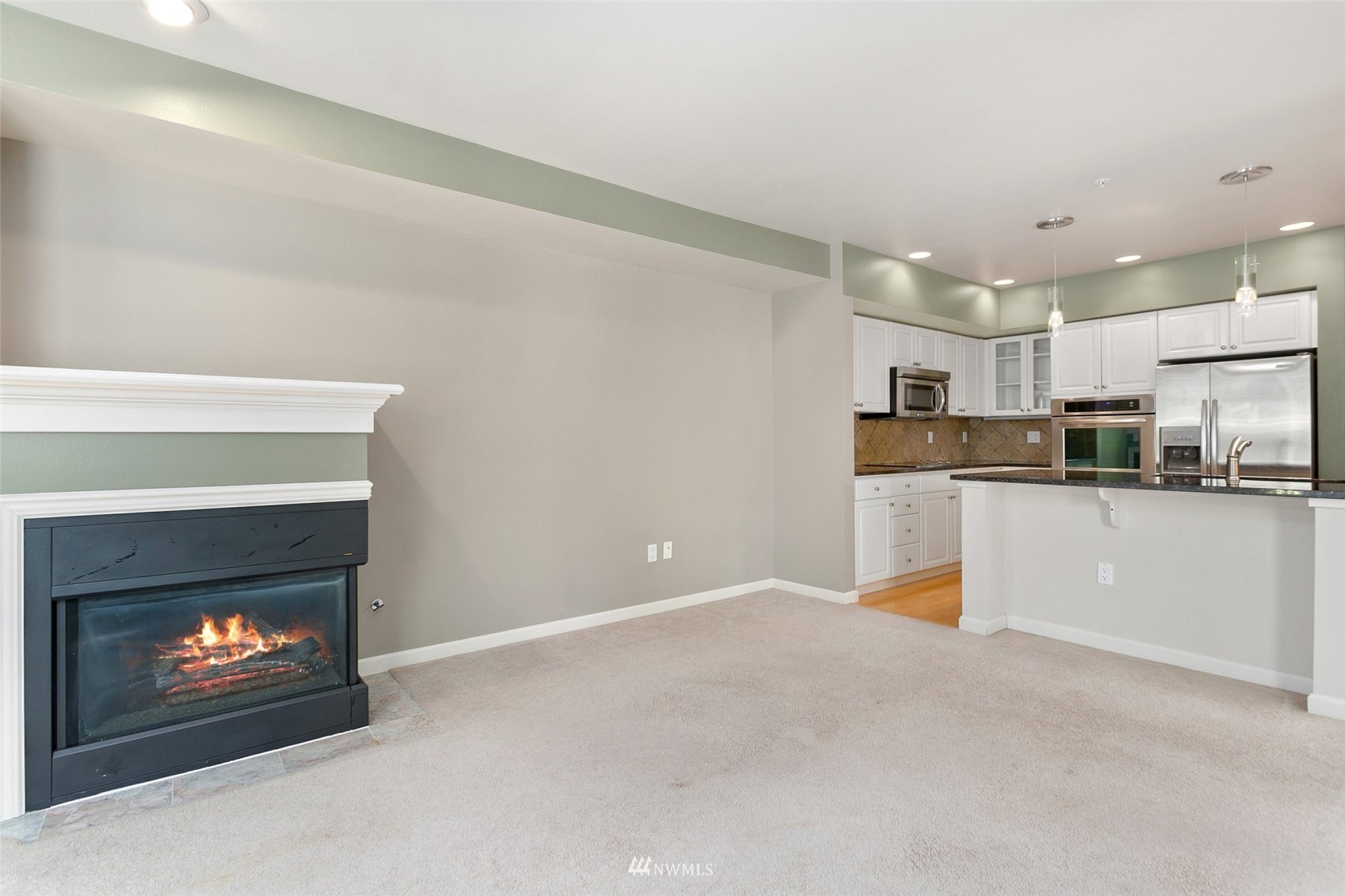 102 State Street, Unit 101W Kirkland, WA 98033 - Photo 11 of 38 a view of kitchen with fireplace and microwave