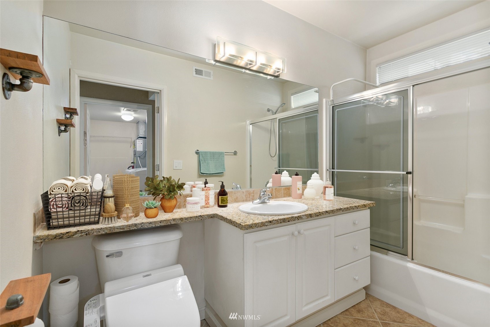 102 State Street, Unit 101W Kirkland, WA 98033 - Photo 25 of 38 a bathroom with a sink a toilet and mirror