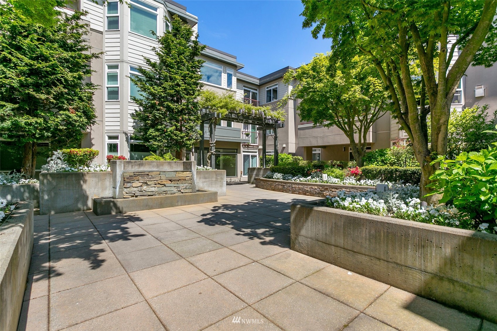 102 State Street, Unit 101W Kirkland, WA 98033 - Photo 28 of 38 a front view of a house with a yard