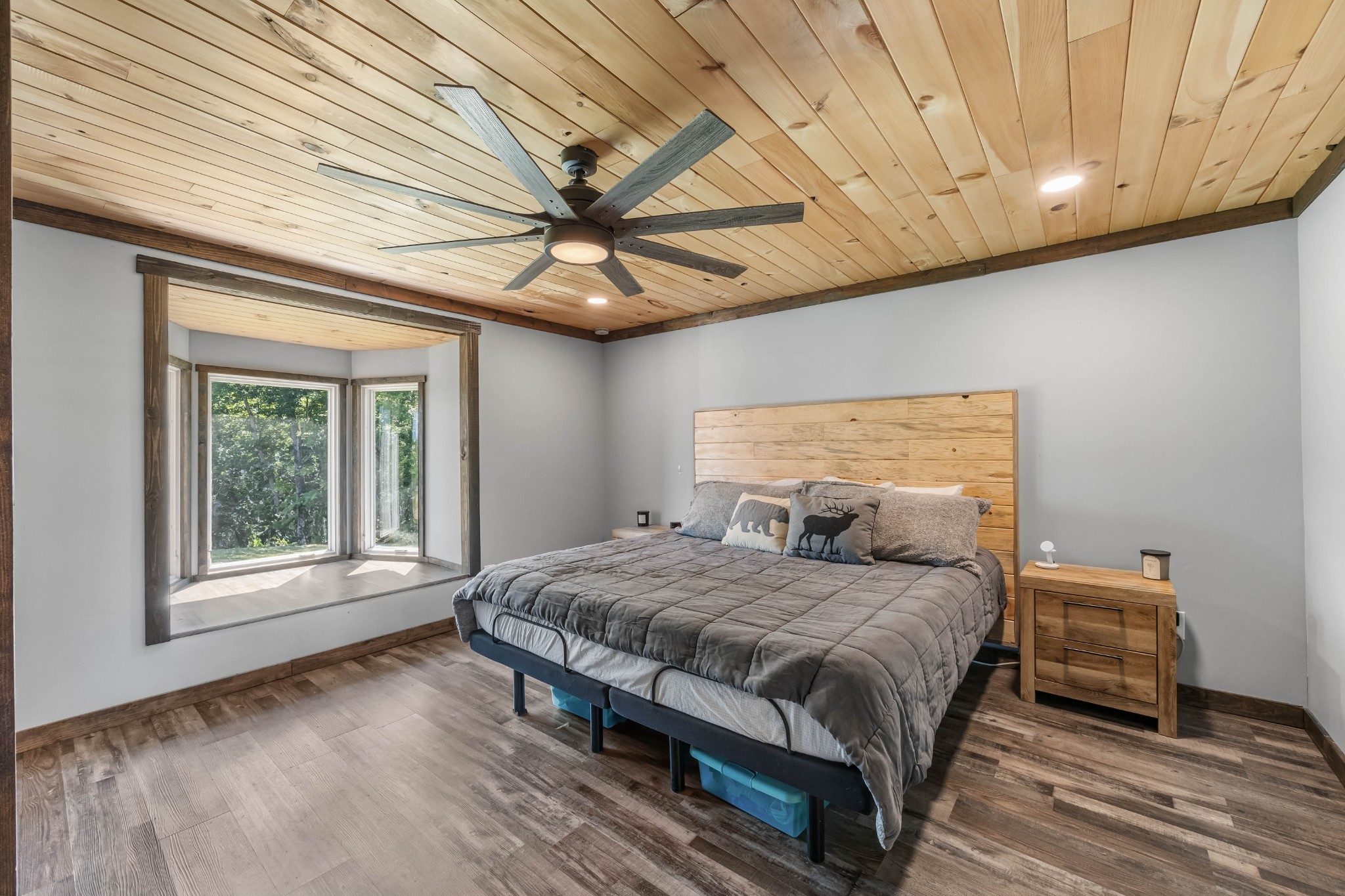 326 Hargis Road Bumpus Mills, TN 37028 - Photo 32 of 67 a bedroom with a bed and a large window with wooden floor