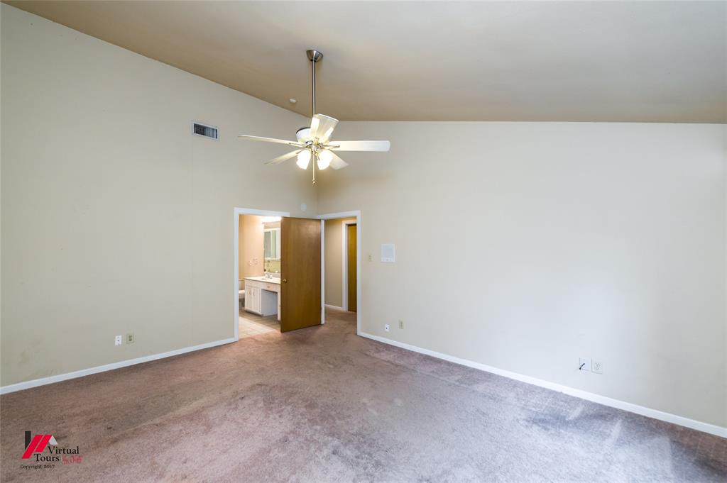 300 Pierremont Road, Unit 40 Shreveport, LA 71106 - Photo 28 of 34 Upstairs primary bedroom with private bath, Vaulted ceiling room with ceiling fan and wall of windows.