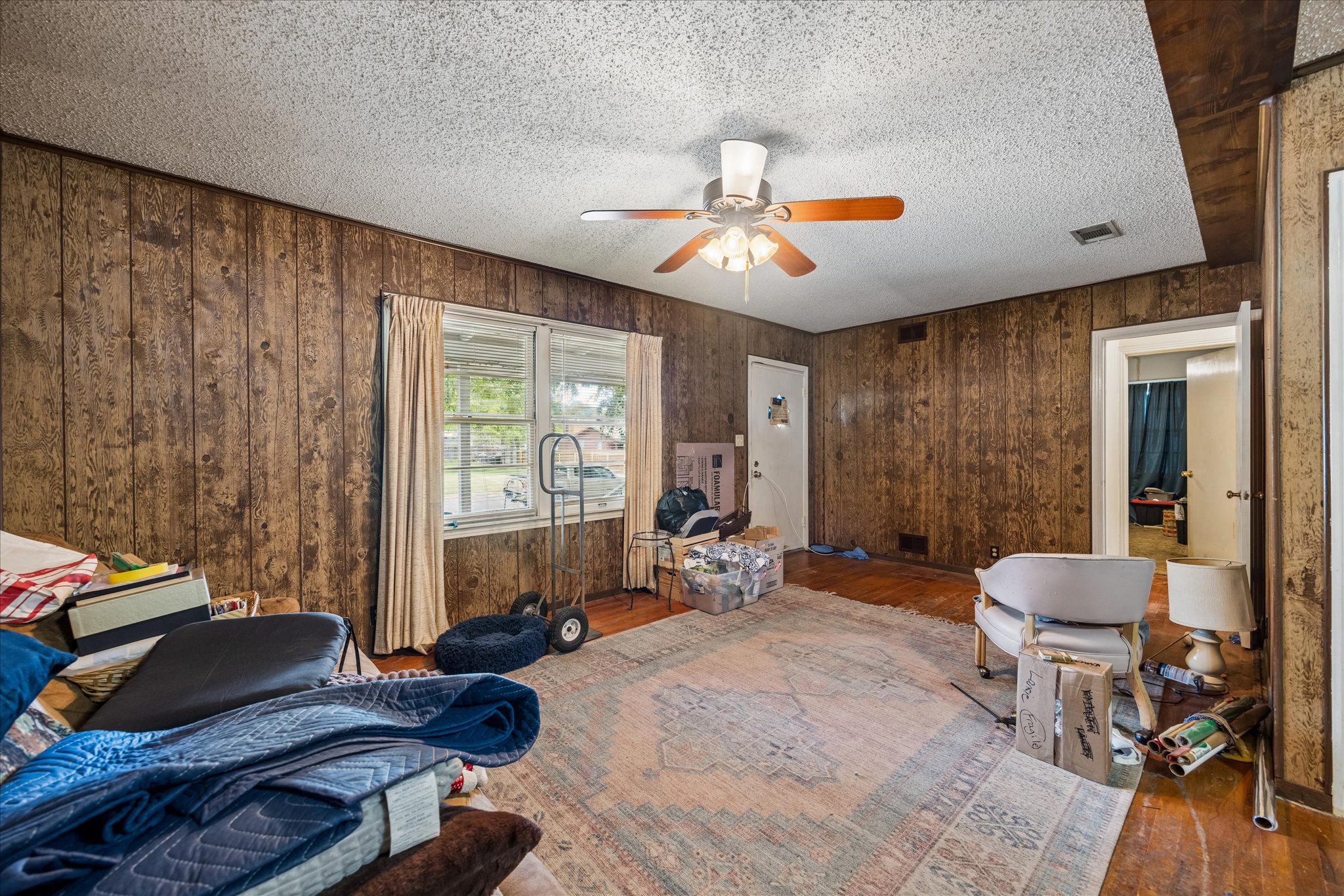 2009 Fort View Road Austin, TX 78704 - Photo 11 of 40 A classic interior space features wood paneling and hardwood floors, creating a cozy and inviting atmosphere.