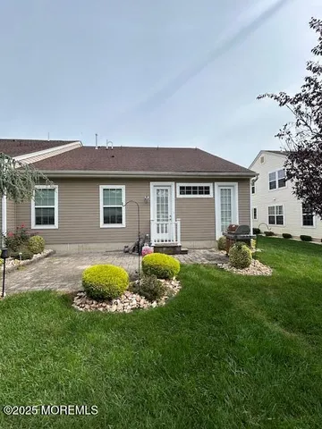 a backyard of a house with table and chairs