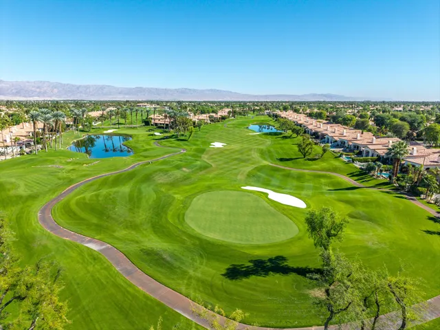 an aerial view of a house with swimming pool and garden