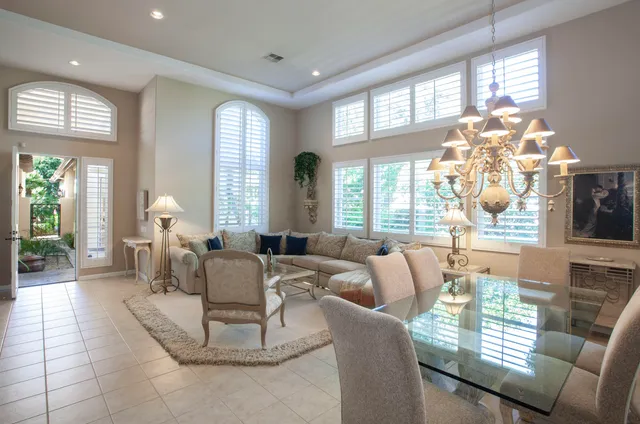 a living room with furniture a chandelier and a fireplace
