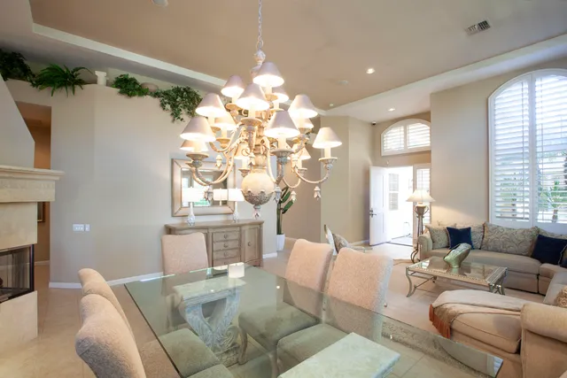 a dining room with furniture and a chandelier