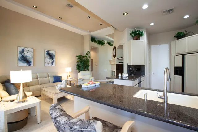 a large white bed sitting in a bedroom next to a window