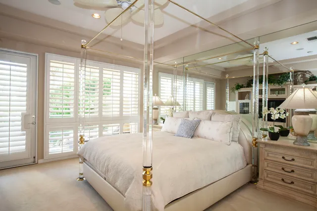 a bedroom with a large bed and a flat tv