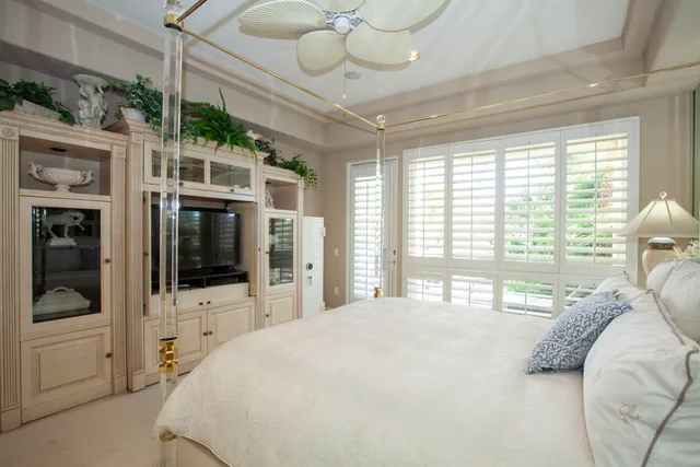 a large bedroom with a large bed and a large window