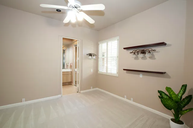 a bathroom with a granite countertop sink two mirror and shower