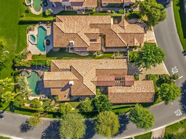 an aerial view of residential houses with outdoor space and street view