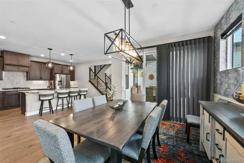 a dining room with furniture and wooden floor