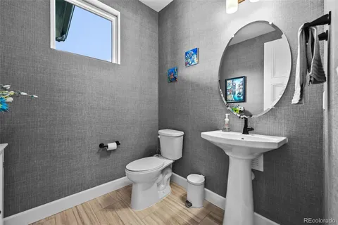 a bathroom with a sink toilet and a mirror