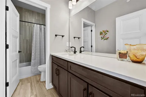 a spacious bathroom with a double vanity sink and a mirror