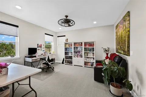 a view of a livingroom with workspace and a window