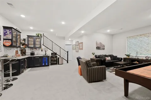 a living room with furniture a flat screen tv and a large window