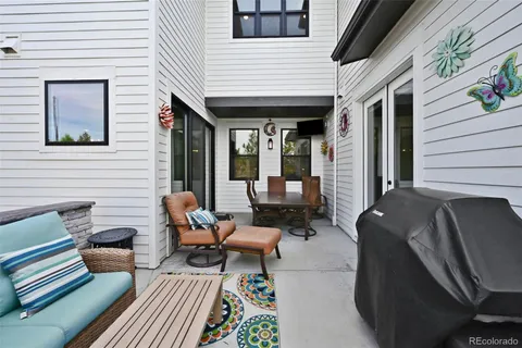 a balcony with furniture and a potted plant
