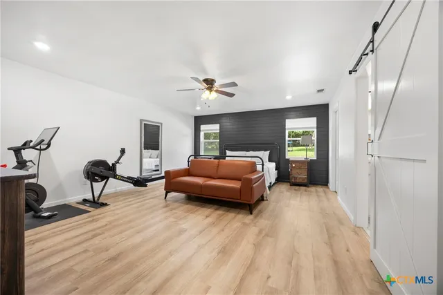a bedroom with furniture and a wooden floor