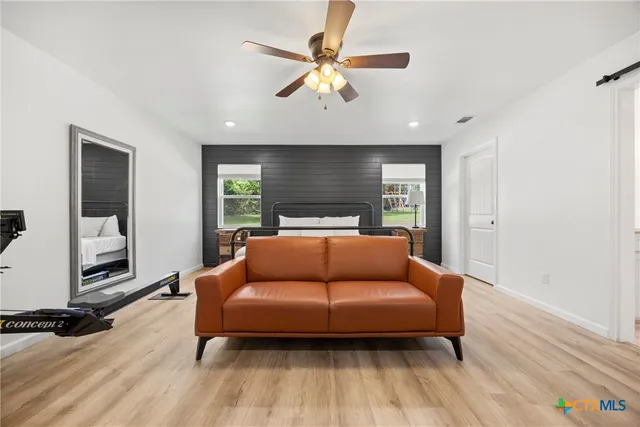 a bedroom with furniture and wooden floor