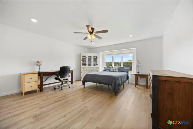 a bedroom with furniture and a wooden floor