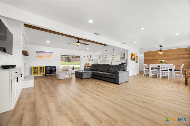 a living room with furniture and kitchen view