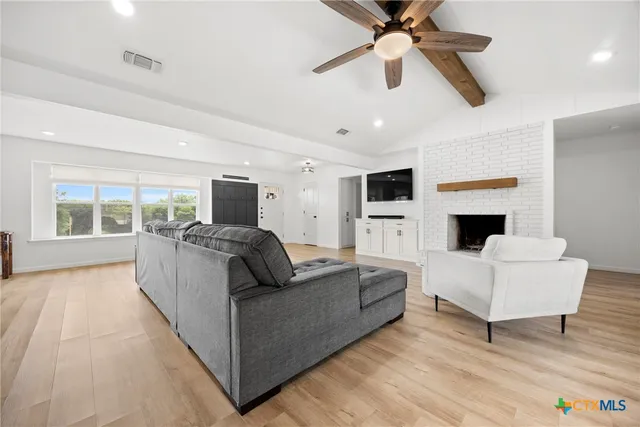 a living room with furniture fireplace and a flat screen tv