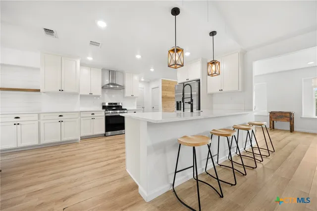 a large kitchen with a table and chairs in it
