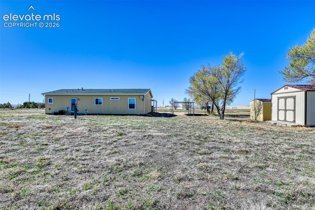 22558 Enoch Road Calhan, CO 80808 - Photo 24 of 50 a front view of a house with a yard