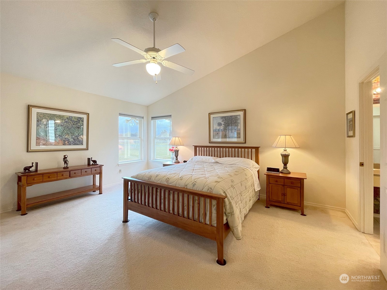 250 Cameron Road Sequim, WA 98382 - Photo 16 of 23 a spacious bedroom with a bed and a chandelier
