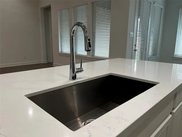 a kitchen with a sink and a mirror