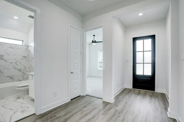 wooden floor in an empty room with a window