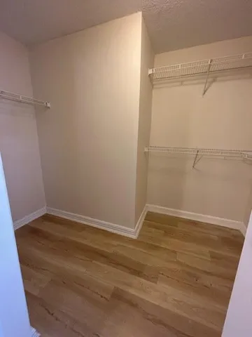 a spacious bathroom with a granite countertop sink a mirror and a