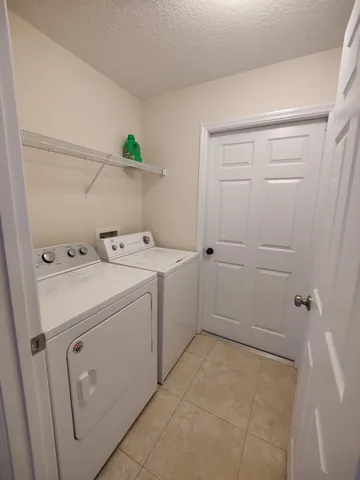 a view of a lake with couches chairs and a potted plant