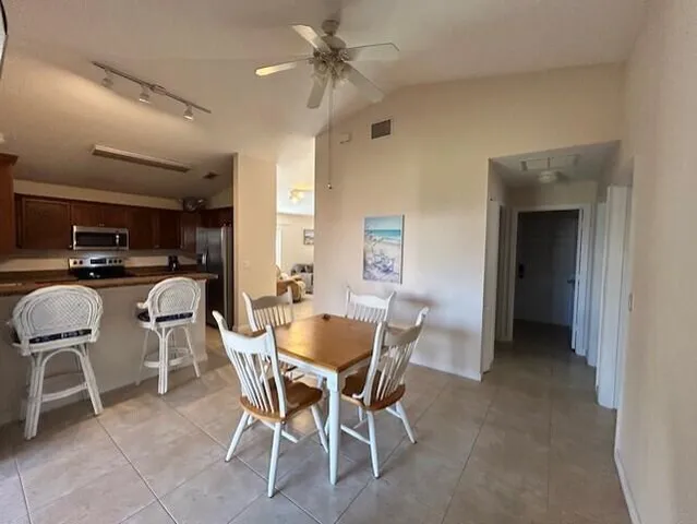 a kitchen with granite countertop a sink cabinets and appliances