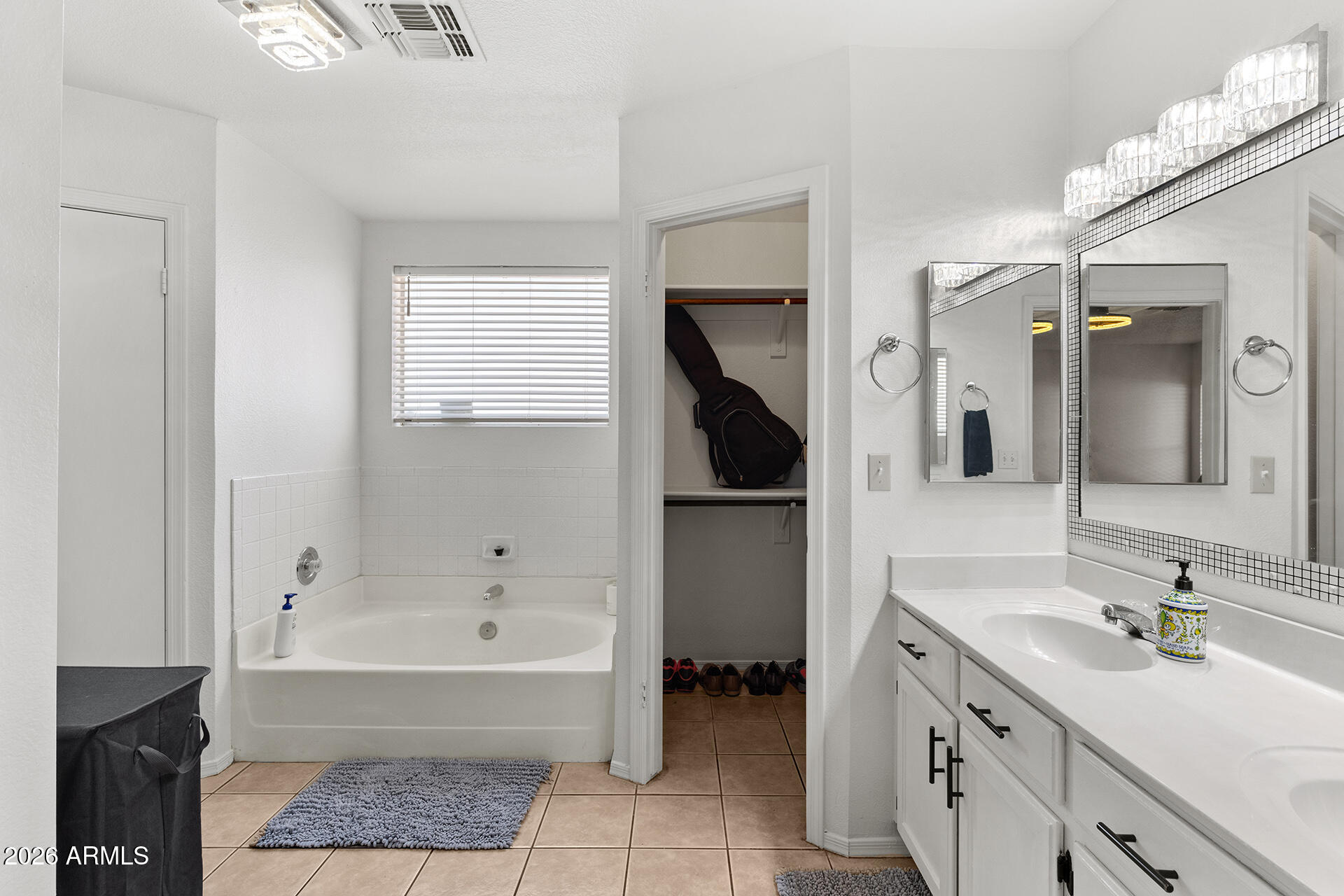 9002 West Coronado Road Phoenix, AZ 85037 - Photo 33 of 54 a bathroom with a tub sink and mirror