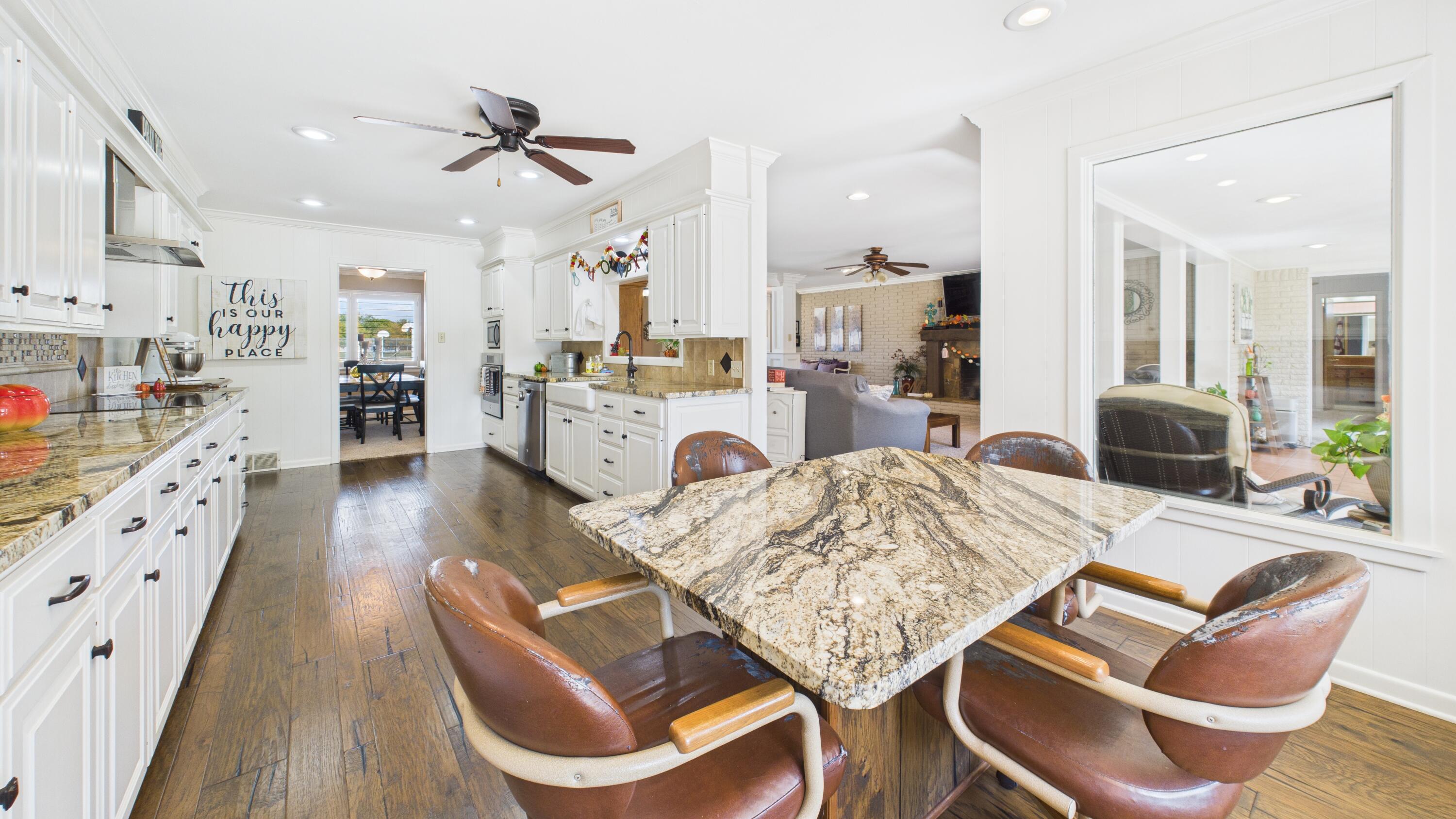 609 North 21st Street Lamesa, TX 79331 - Photo 17 of 50 a living room with furniture kitchen view and a wooden floor