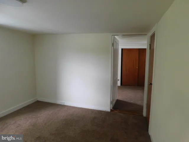 a view of an empty room and closet area