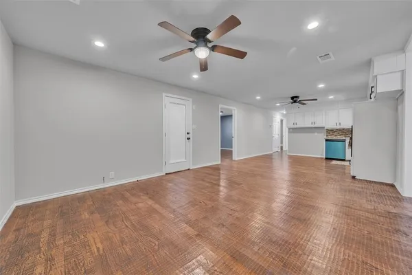 a view of an empty room with a ceiling fan