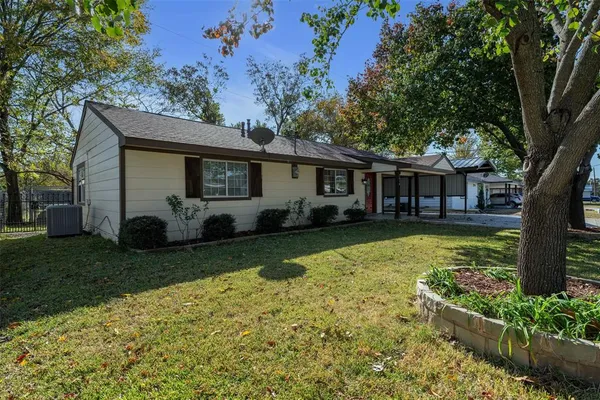 a view of a house with a yard patio and a small yard