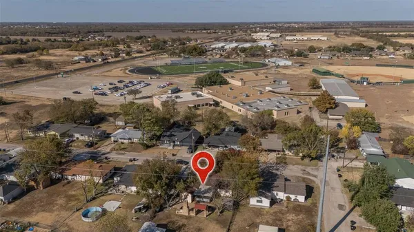 an aerial view of residential houses with outdoor space