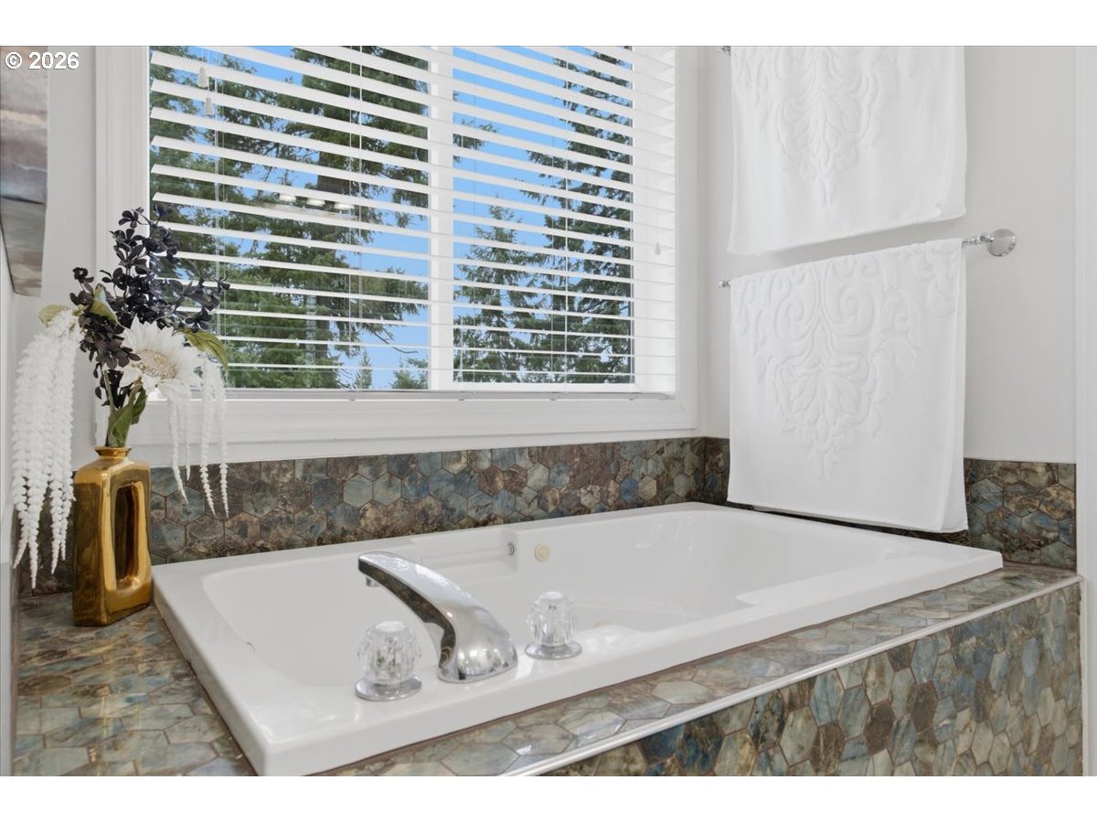 2469 Dalke Ridge Drive Northwest Salem, OR 97304 - Photo 19 of 42 a bath tub sitting in a bathroom next to a window