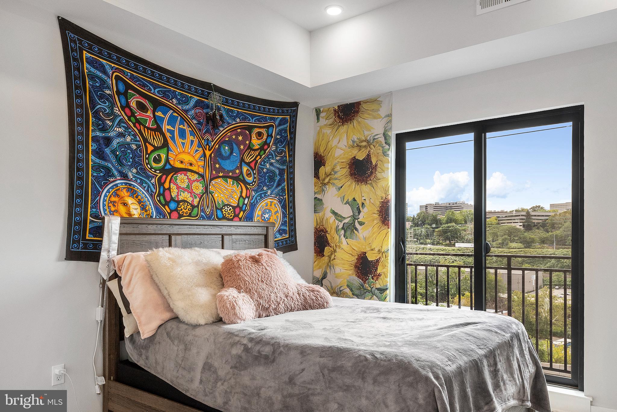 5102 Rochelle Avenue, Unit 8 Philadelphia, PA 19128 - Photo 6 of 13 a bedroom with a bed and a painting on the wall