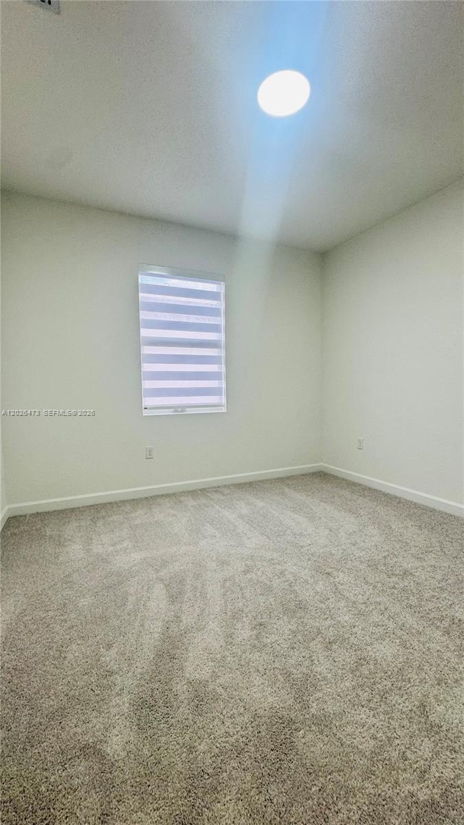 19479 Southwest 340th Street, Unit 1 Homestead, FL 33034 - Photo 22 of 58 an empty room with a empty space and windows
